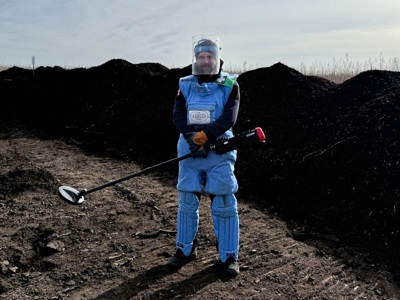HALO deminer holding a detector